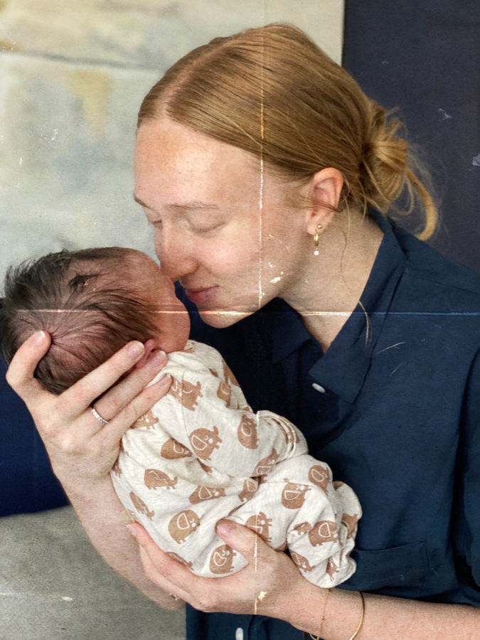 em kissing her newborn